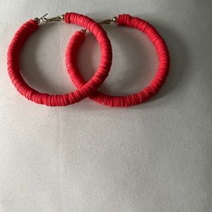 Red hoop earrings.